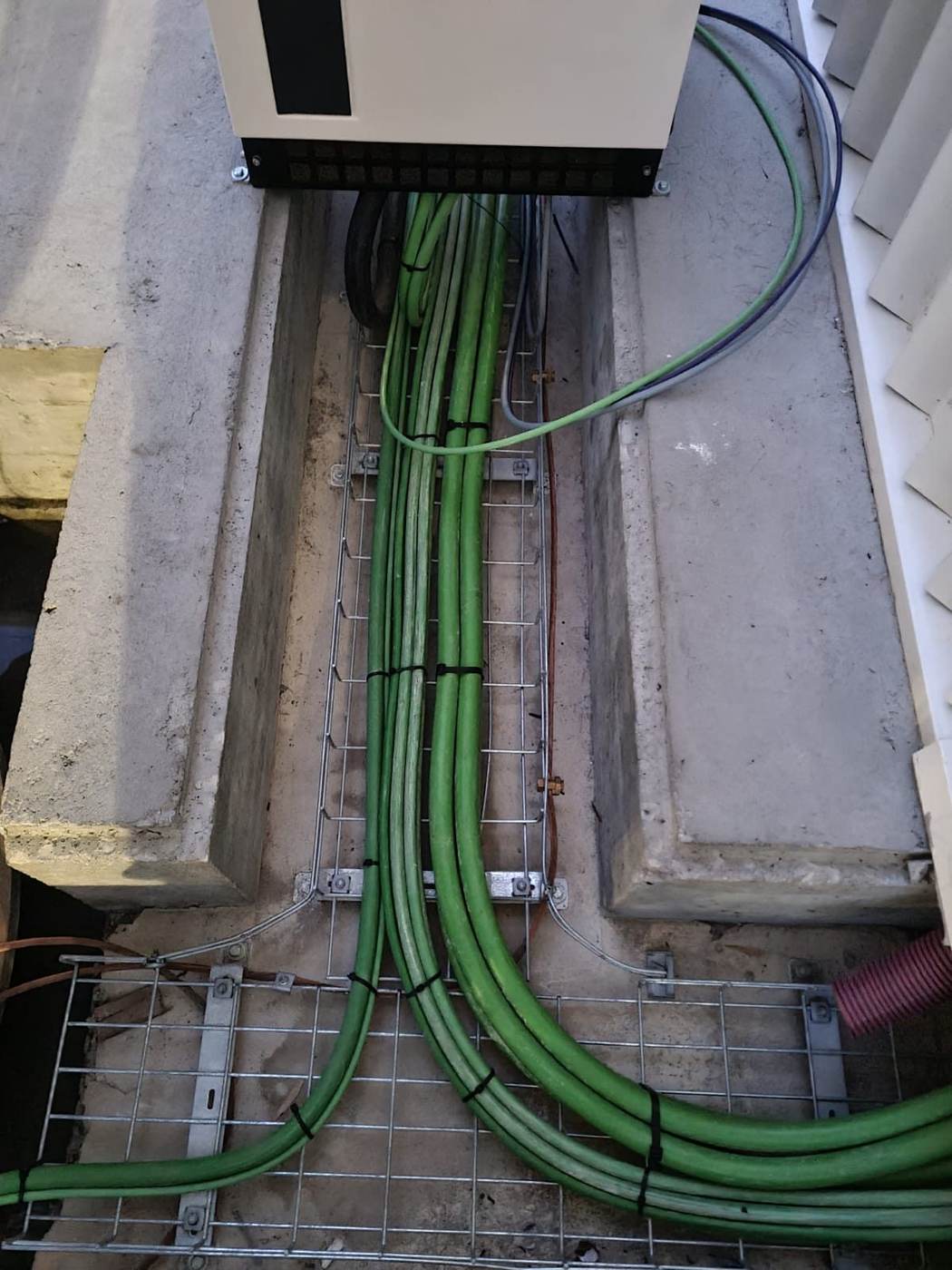 Cables de potencia sobre bandeja metálica saliendo de un cuadro
